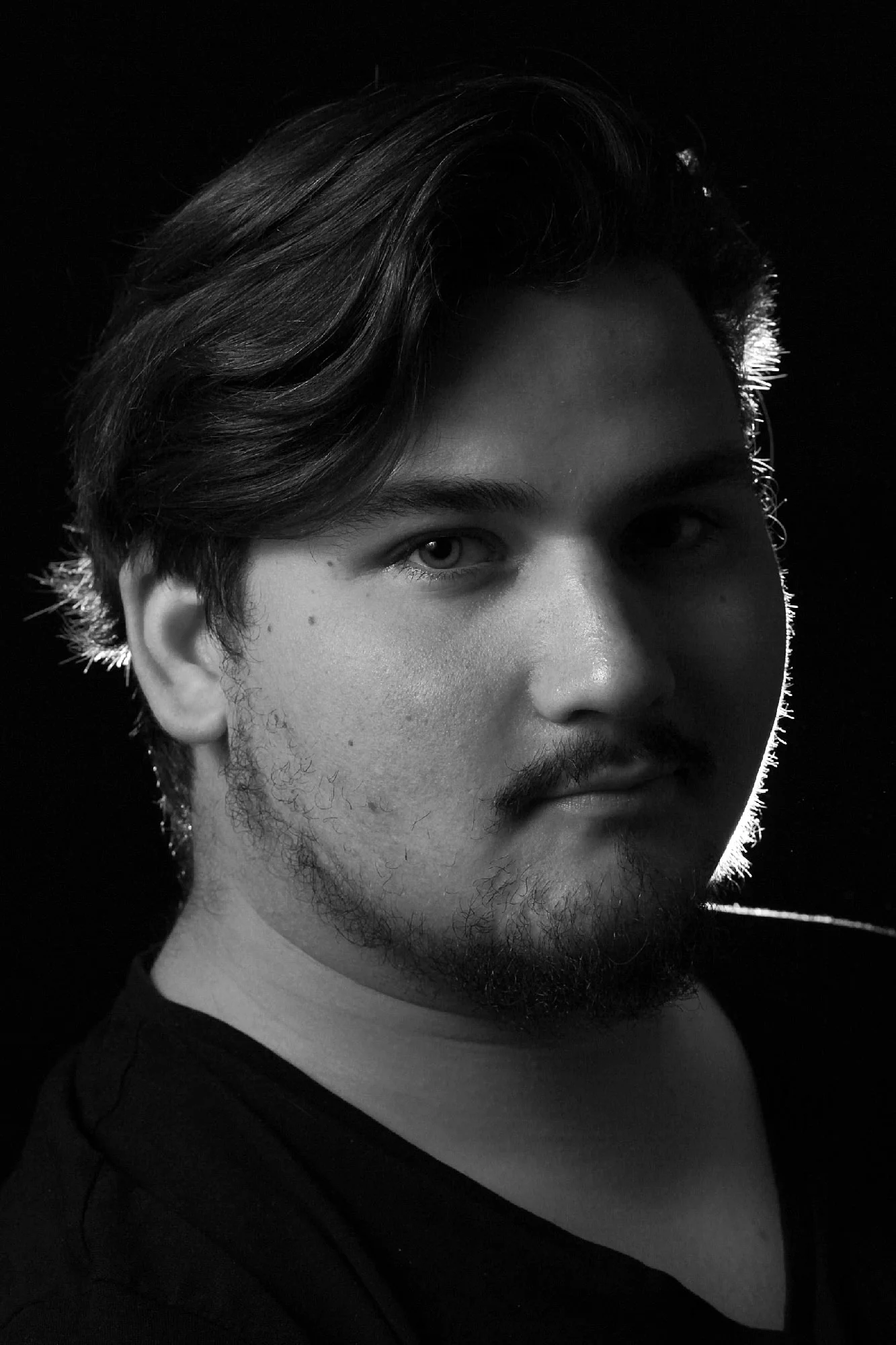 Black-and-white portrait of a young man turned slightly to the side