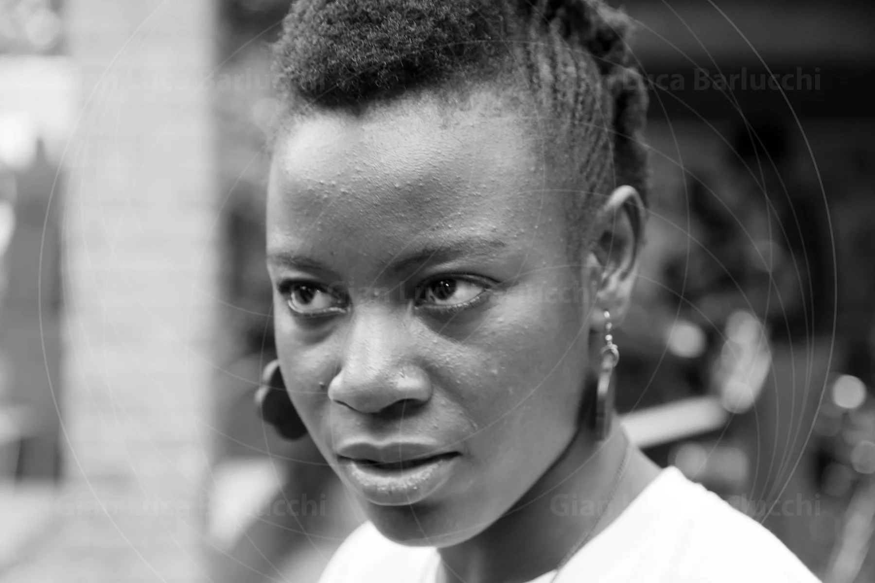 Black-and-white portrait of a woman with short hair looking to the side